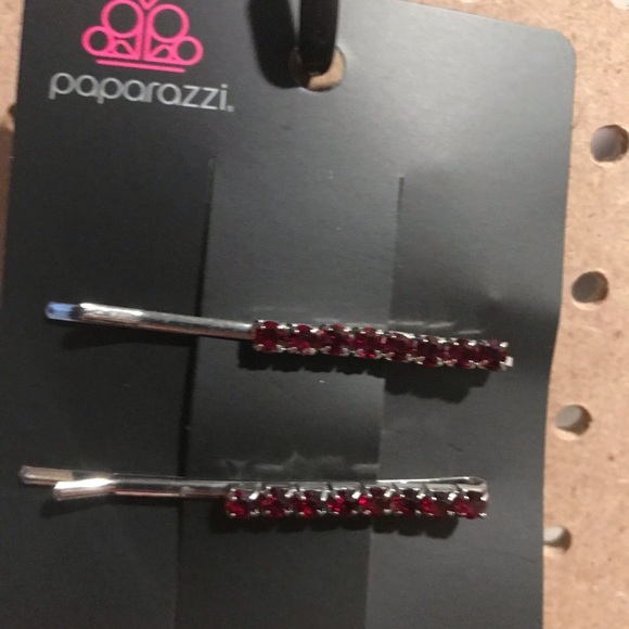 Two pin hair clips with red rhinestones.